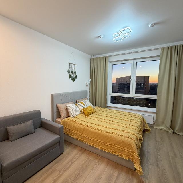 Studio apartment with a bed and an armchair 